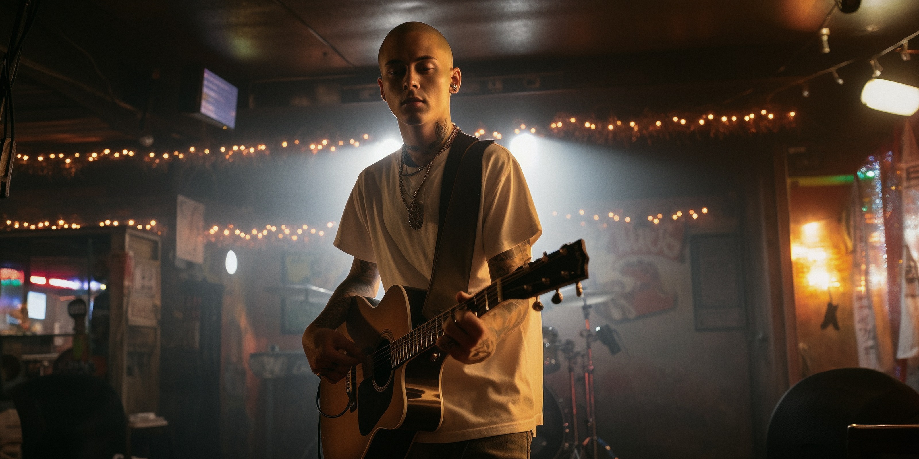 A guitarist playing on the bar stage.